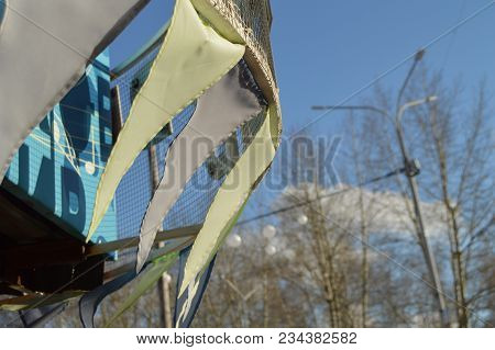 Close-up, Selective Focus, Wind Slaps Garlands Of Colorful Flags Against Blue Sky, Park In Spring.