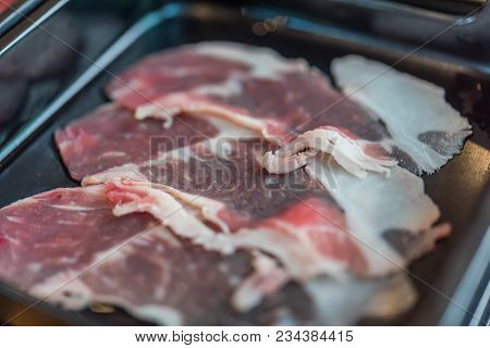 Beef Raw Meat Slides On Dish At Bbq. Restaurant