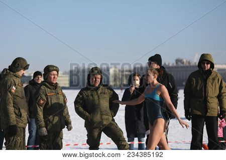 ST. PETERSBURG, RUSSIA - MARCH 4, 2018: Female amateur winter swimmer at ice hole during Big Neva Cup. Winter swimmers from 12 countries aged from 12 to 78 take part in the competitions this year