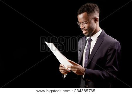 African Happy Student Wearing Stylish Suit Reading A Report. Perform In The Conference. Present Dipl