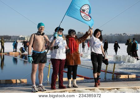 ST. PETERSBURG, RUSSIA - MARCH 4, 2018:  Representatives of club Winter Swimmers of Capital City during winter swimming competitions for Big Neva Cup. Winter swimmers from 12 countries participate