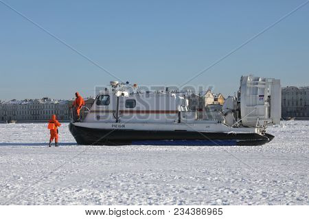 ST. PETERSBURG, RUSSIA - MARCH 4, 2018: EMERCOM staff at their hovercraft during winter swimming competitions Big Neva Cup. Winter swimmers from 12 countries take part in the competitions
