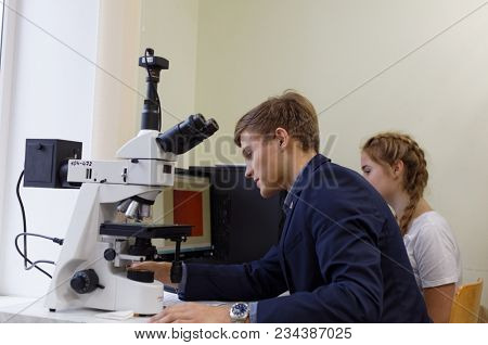 ST. PETERSBURG, RUSSIA - OCTOBER 16, 2017: Schoolchild at microscope in a classroom of the physics and mathematics lyceum 366. This year lyceum celebrates its 70th anniversary