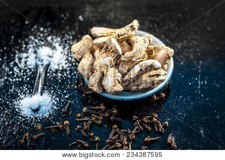 Close Up Of Ayurvedic Herb Or Folk Medicine Dried Ginger Or Zingiber Officinale With Black Pepper Co