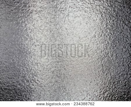 The Surface Of The Glass Is Opaque. Light Background From A Light Bulb With Glitter On The Glass. Te
