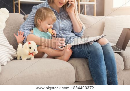 Happy Beautiful Business Mom Working With Documents And Talking On Smartphone In Home Office While H