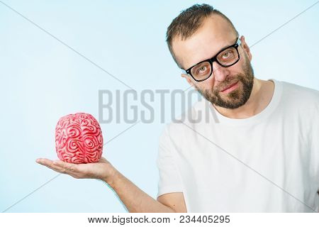Adult Nerd Man Wearing Eyeglasses Looking At Human Brain Model. Thinking And Intelligence Conept