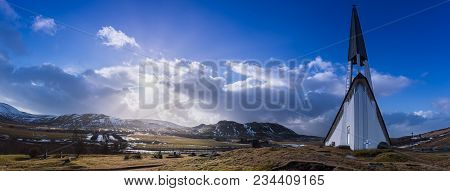 Panorama Of The Mosfellsbaer Church In Iceland At Sunset With A Cross, Graves, Green Grass, Mountain