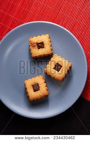 Chocolate Sand Chip Cookies Stacked Up On A Plate, Ready To Be Served.