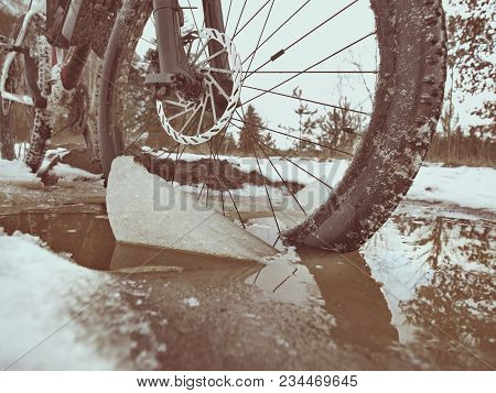 Mudd And Water Drops On Bike Tyre. Winter Free Ride In Snowy Landscape.  Low Temperature, Cloudy Sky