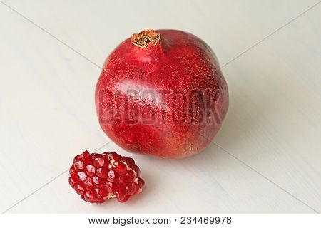 Big Ripe Red Granets Or Garnets. Fruits Of Red Ripe Pomegranate On The White Background. Vegetarian 