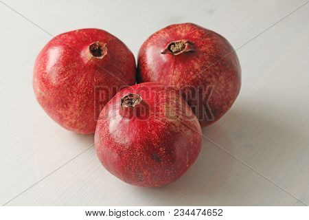 Big Ripe Red Granets Or Garnets. Fruits Of Red Ripe Pomegranate On The White Background. Vegetarian 