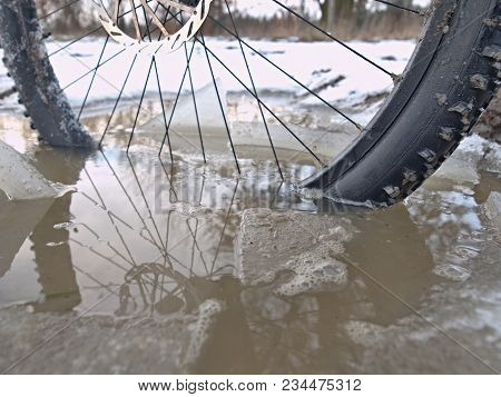 Bike Drowned In Muddy Pool Within Winter Trip. Broken Pieces Of Ice Around Freeze Terain Tyre, Wide 
