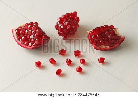 Big Ripe Red Granets Or Garnets. Fruits Of Red Ripe Pomegranate On The White Background. Vegetarian 
