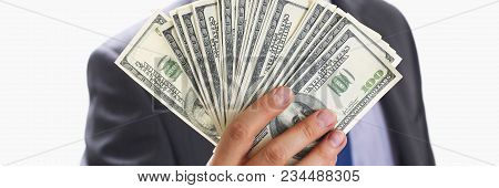 Man In Suit And Tie Hold In Arm Pack Of Hundred Dollar Bills Closeup. Stock Market Exchange Earn Pil