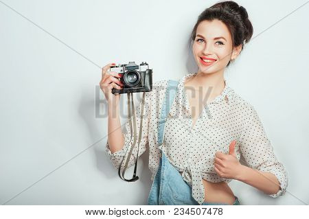 Cool! Pretty Cool Young Woman Model With Retro Camera Wearing In Denim Clothes Posing On White Wall.