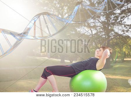woman doing exercise with the baal in the park. DNA chain over her