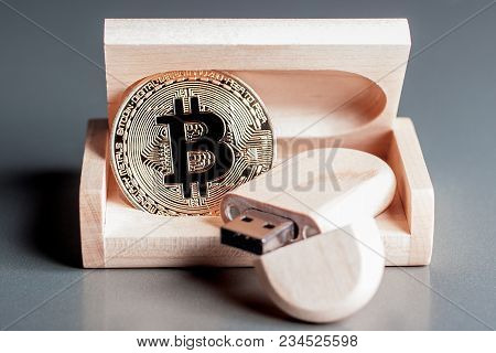 Bitcoin Gold Coin In A Wooden Box Along With A Usb Flash Drive