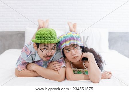 Couple Asian Man And Woman With Woolhat Together Funny Moment On White Bed