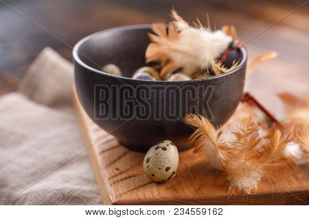 Quail Eggs In Ceramic Mug, Napkin, Wooden Board On Wooden Table. Quail Eggs Similar In Color With A 