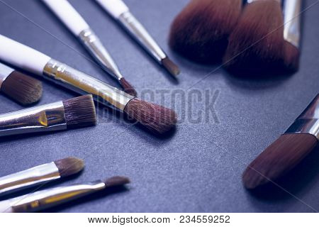 A Set Of Profeccional Make Up Brushes On A Dark Background, Close Up