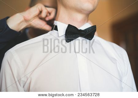 Happy Handsome Smiling Groom Posing With Boutonniere.