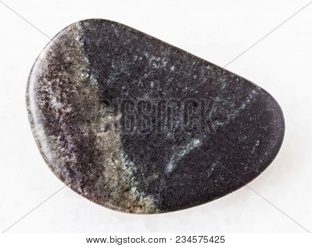 Macro Shooting Of Natural Mineral Rock Specimen - Polished Olivinite Stone On White Marble Backgroun