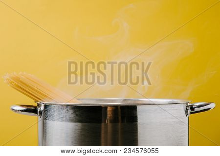 Delicious Spaghetti Boiling In Stewpot Isolated On Yellow