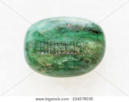 Macro Shooting Of Natural Mineral Rock Specimen - Tumbled Green Beryl Gemstone On White Marble Backg