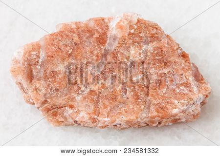 Macro Shooting Of Natural Mineral Rock Specimen - Slab From Raw Pegmatite Stone On White Marble Back