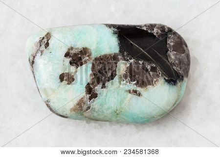 Macro Shooting Of Natural Mineral Rock Specimen - Tumbled Pegmatite Stone On White Marble Background