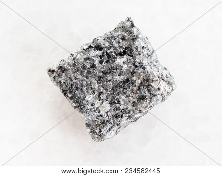 Macro Shooting Of Natural Mineral Rock Specimen - Raw Gabbro Stone On White Marble Background