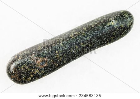 Macro Shooting Of Natural Mineral Rock Specimen - Tumbled Tholeiite Basalt Stone On White Marble Bac