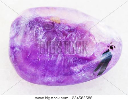 Macro Shooting Of Natural Mineral Rock Specimen - Polished Charoite Gemstone On White Marble Backgro