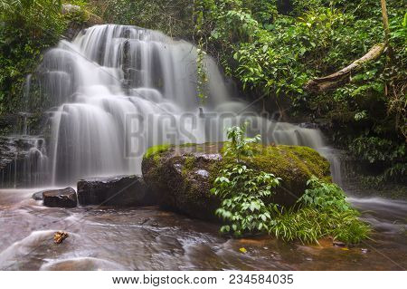 Mun Dang Waterfall With A Pink Flower Foreground In Rain Forest At Phitsanulok Province, Thailand