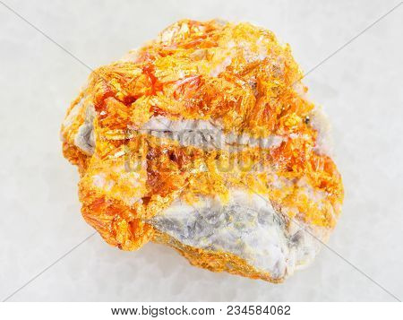 Macro Shooting Of Natural Mineral Rock Specimen - Raw Yellow Orpiment Crystals On White Dolomite Sto