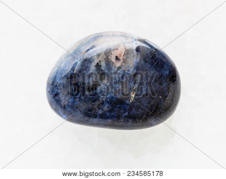 Macro Shooting Of Natural Mineral Rock Specimen - Polished Dumortierite Gem Stone On White Marble Ba