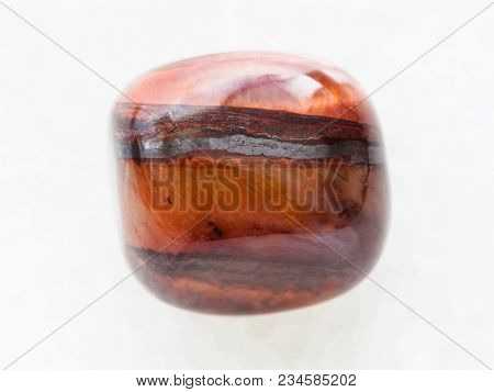 Macro Shooting Of Natural Mineral Rock Specimen - Polished Jaspilite Gem Stone On White Marble Backg