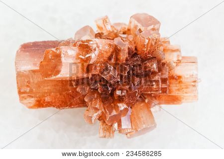 Macro Shooting Of Natural Mineral Rock Specimen - Rough Crystal Of Aragonite Gemstone On White Marbl