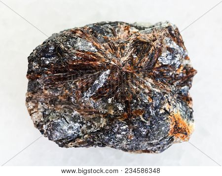 Macro Shooting Of Natural Mineral Rock Specimen - Raw Lamprophyllite Stone On White Marble Backgroun