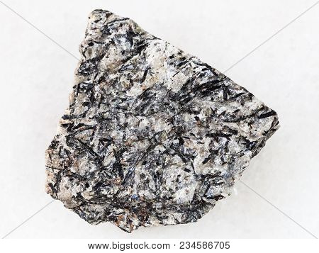 Macro Shooting Of Natural Mineral Rock Specimen - Rough Lujavrite Stone On White Marble Background F