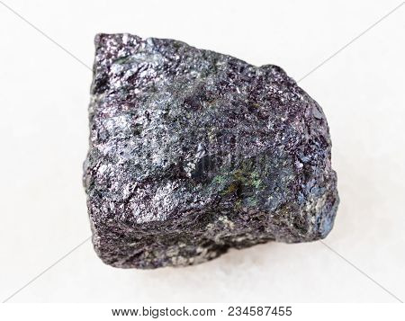 Macro Shooting Of Natural Mineral Rock Specimen - Piece Of Bornite Stone On White Marble Background 