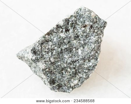 Macro Shooting Of Natural Mineral Rock Specimen - Raw Diorite Stone On White Marble Background