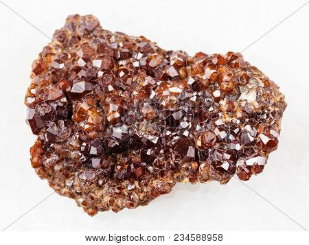 Macro Shooting Of Natural Mineral Rock Specimen - Rough Andradite Garnet Crystals On Stone On White 