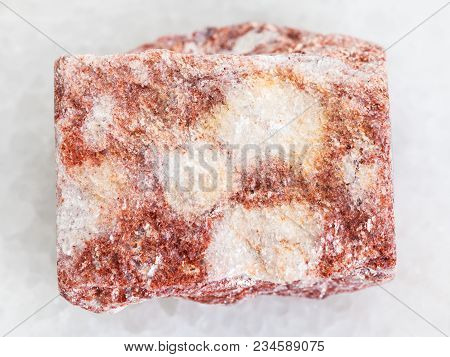 Macro Shooting Of Natural Mineral Rock Specimen - Rough Pink Aventurine Stone On White Marble Backgr