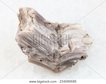 Macro Shooting Of Natural Mineral Rock Specimen - Rough Baryte Stone On White Marble Background From