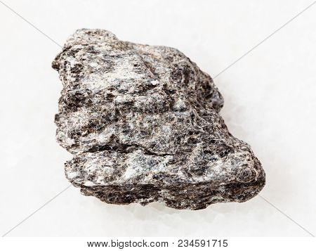 Macro Shooting Of Natural Mineral Rock Specimen - Rough Quartz-biotite Schist Stone On White Marble 