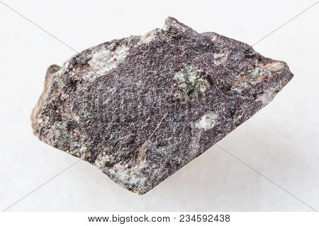 Macro Shooting Of Natural Mineral Rock Specimen - Raw Porphyritic Basalt Stone On White Marble Backg