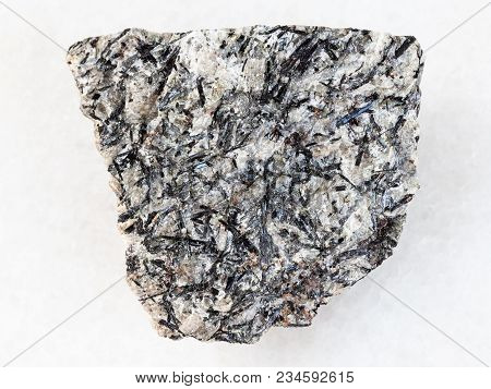 Macro Shooting Of Natural Mineral Rock Specimen - Raw Lujavrite Stone On White Marble Background Fro