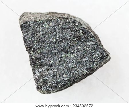 Macro Shooting Of Natural Mineral Rock Specimen - Rough Gabbro Stone On White Marble Background